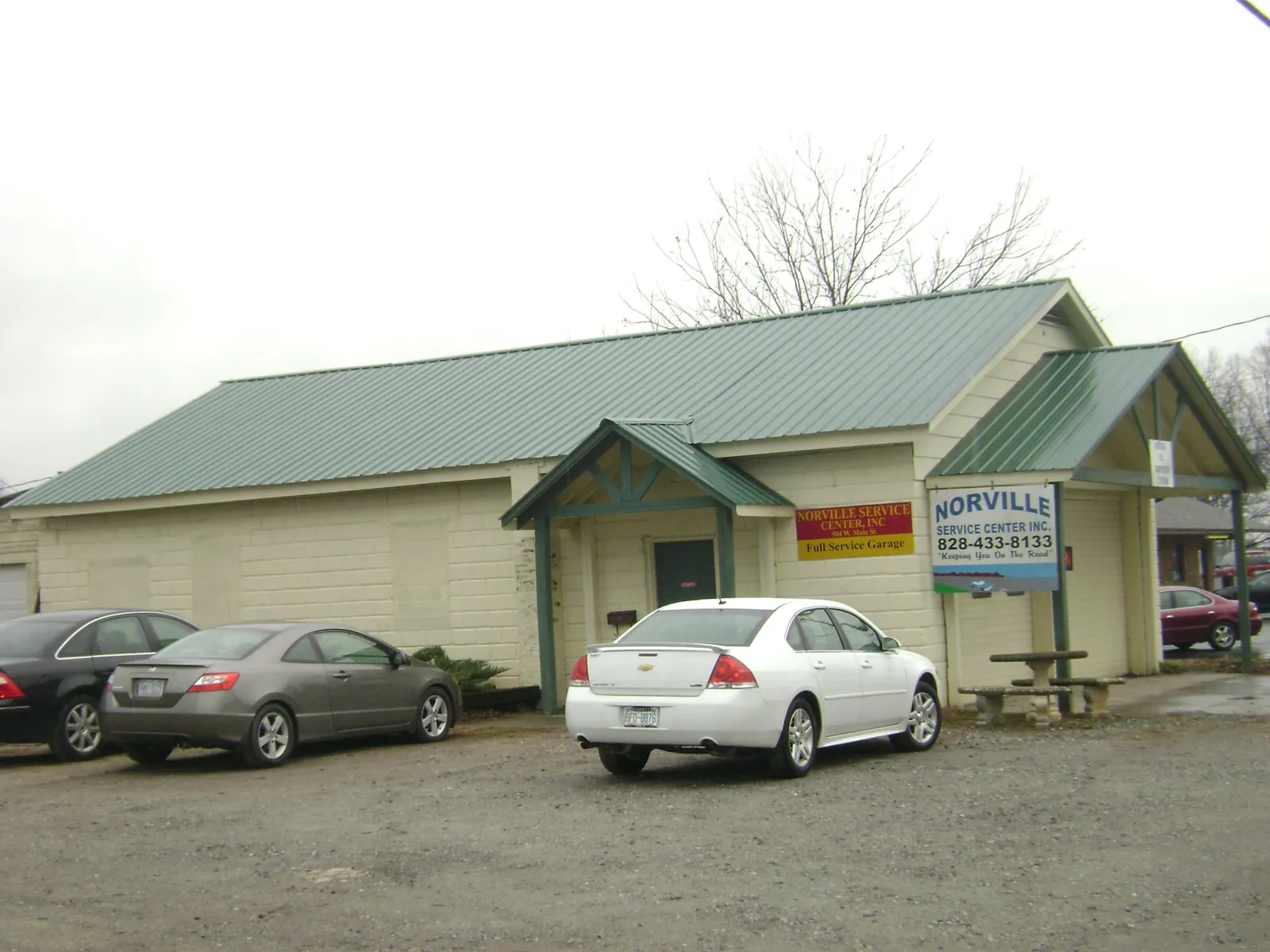 Green metal roof on a service garage with a covered entry in Pleasant Grove